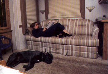 Gillian on her coach reading and Cleo laying on the floor